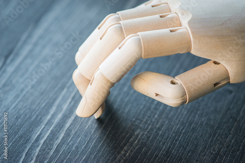 Artificial wooden hand on a wooden table