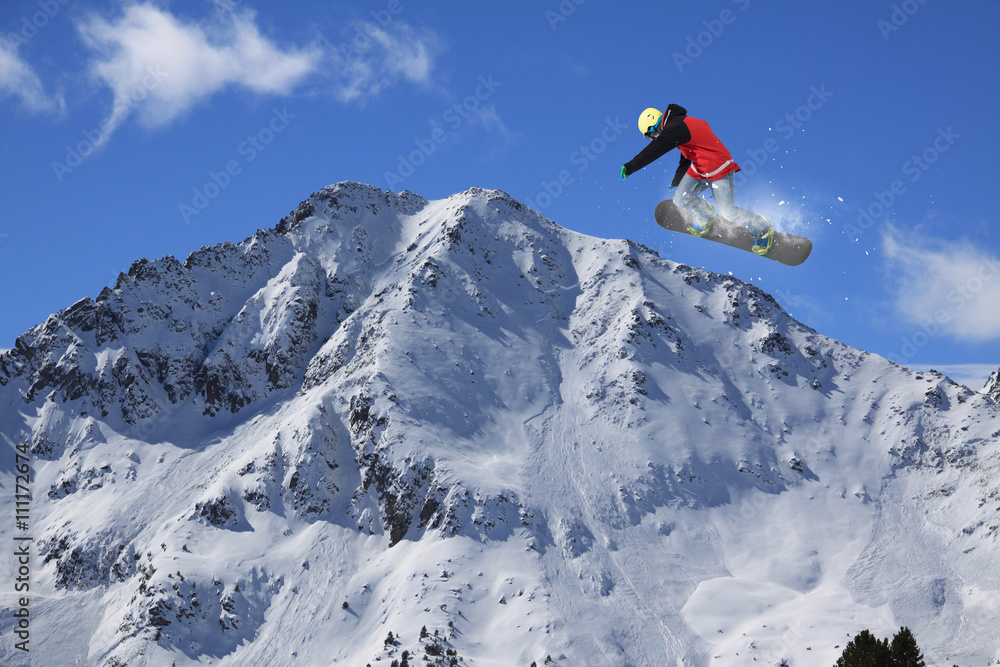 Snowboard rider jumping on winter mountains. Extreme snowboard freeride sport.
