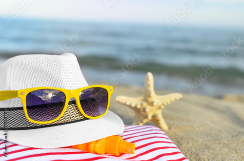 The hat and sunglasses on the beach.