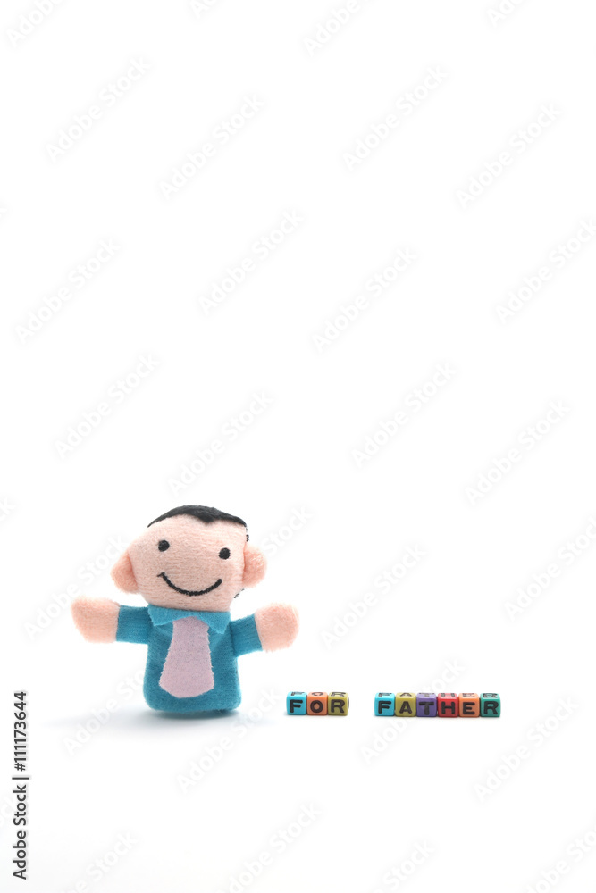 Doll of father with alphabet blocks that spell father. Doll of father with alphabet blocks that spell father.