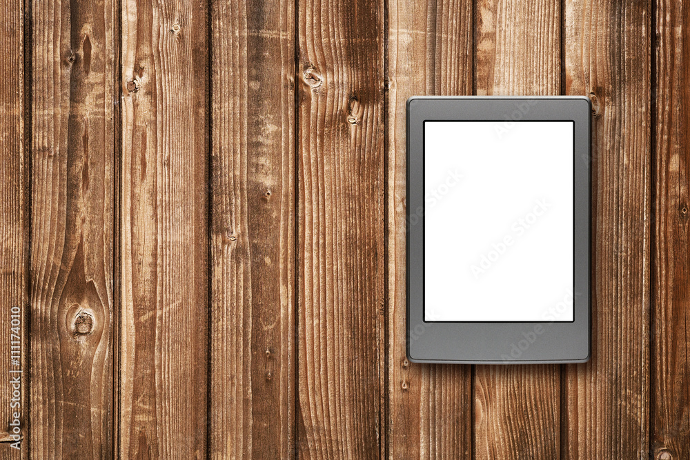 E-book reader on wooden background E-book reader on wooden background