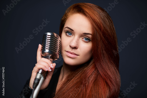 Closeup of young woman with retro microphone