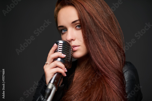 Closeup of young woman with retro microphone