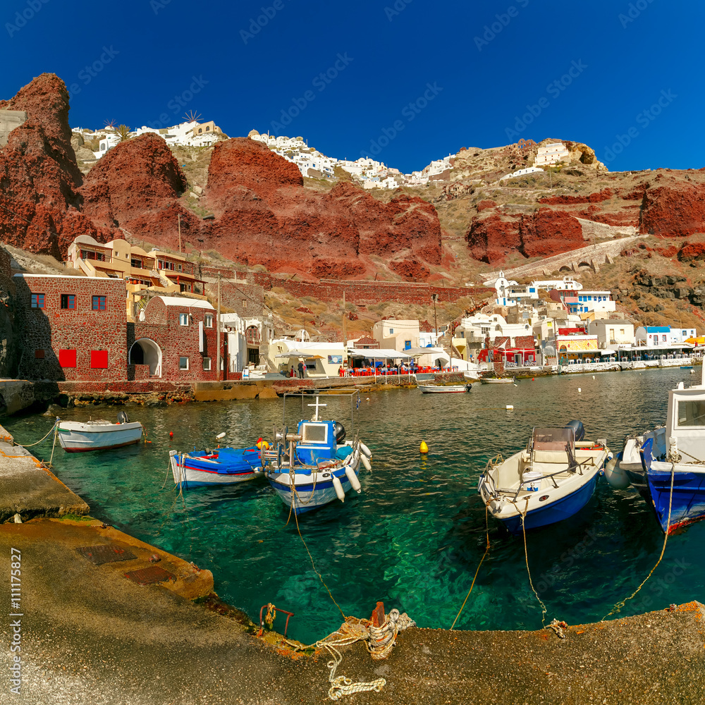Fishing boats at Old port Amoudi of Oia village at Santorini island in Aegean sea, Greece