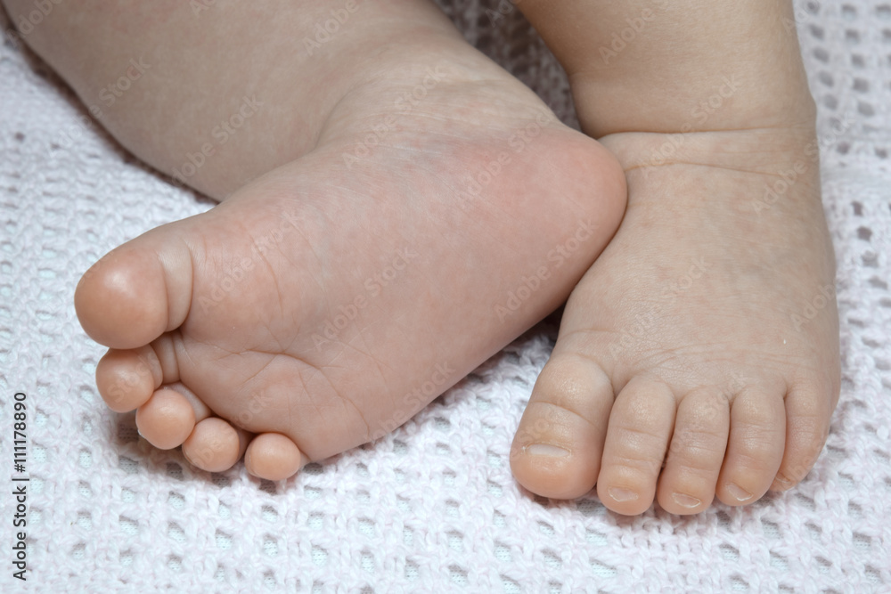 Newborn baby small legs on blanket, cute toes closeup Newborn baby small legs on blanket, cute toes closeup
