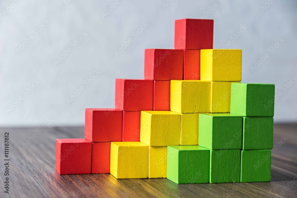 Fototapeta premium Colorful stack of wood cube building blocks