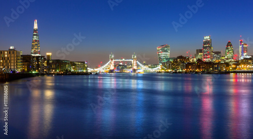 Tower Bridge and cityscape of London at night  UK
