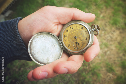 Old pocket watch in a man's hand