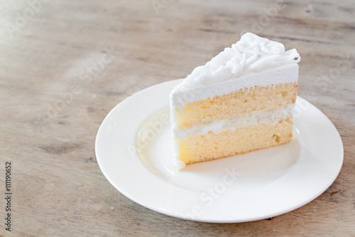Coconut cake on white plate.