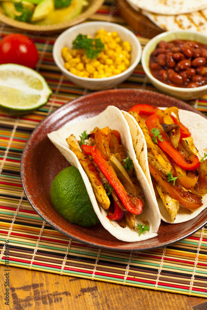 Fajita Chicken Tacos with Grilled Onions and Bell Peppers. Selective focus. Fajita Chicken Tacos with Grilled Onions and Bell Peppers. Selective focus.