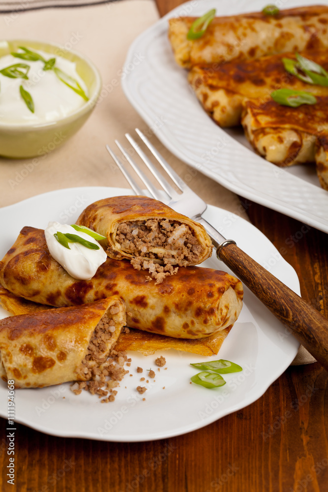 Traditional Russian Fried Stuffed Pancakes Blintzes with Meat. Selective focus.