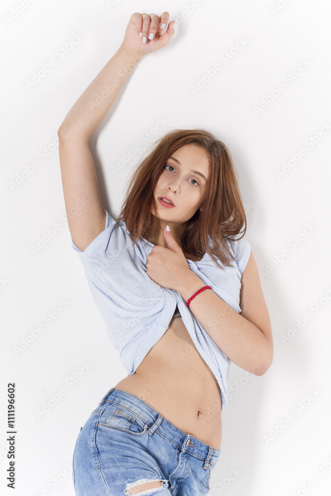 attractive girl in jeans posing on white background attractive girl in jeans posing on white background