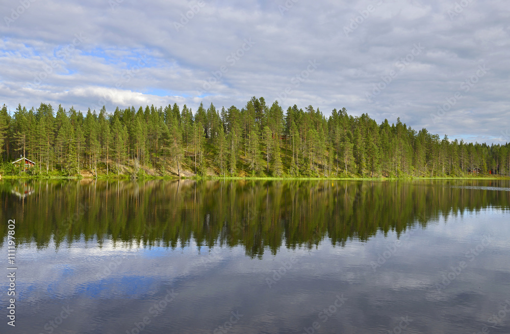 Northern landscape with a lake. Reflection