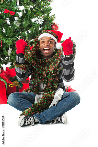 aggrivated young man holding christmas decorations. photo