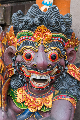 Dragon wooden sculpture on temple door in Bali, Indonesia