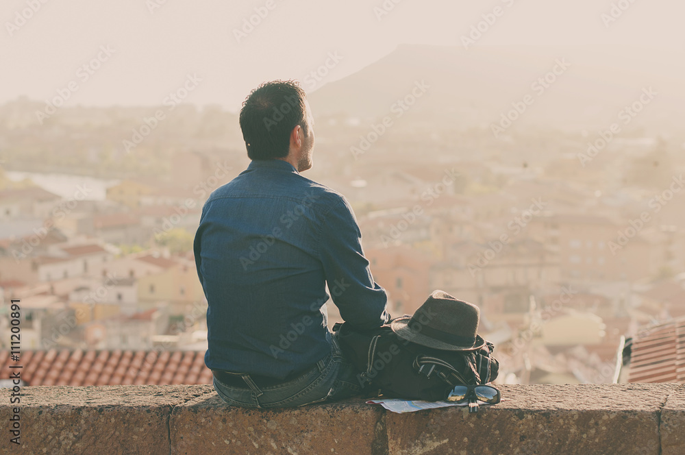 Tourist man looking on the city center during his trip in italy