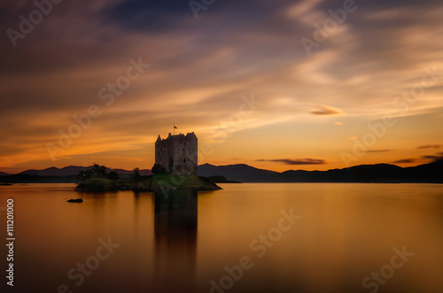 Stalker Castle reflection in orange sunset light, Highlands, Scotland