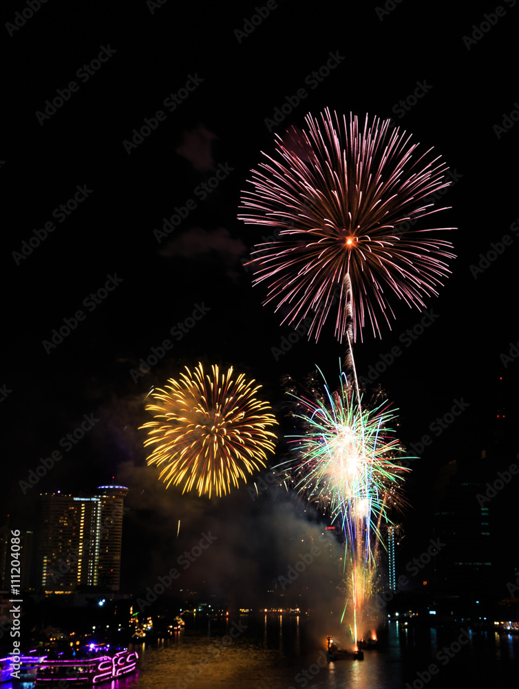 Fireworks over Chaopraya river near hotel in Bangkok Thailand