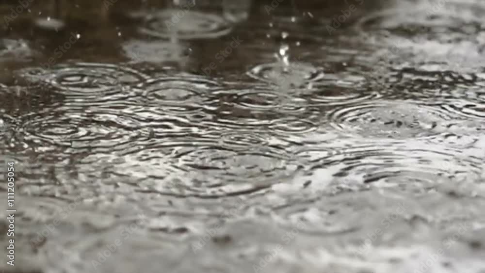 Rain drops dripping in a puddle - slow motion
Rain drops dripping in a puddle - slow motion