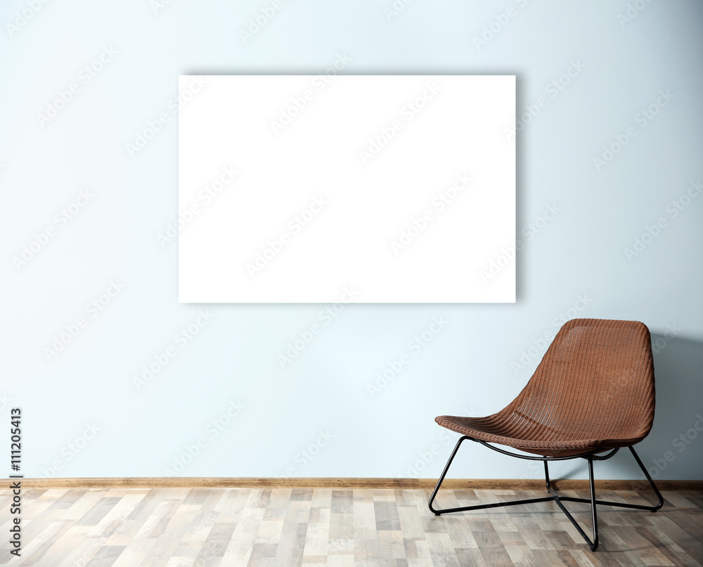 Comfortable chair and empty picture frame on blue wall background Comfortable chair and empty picture frame on blue wall background