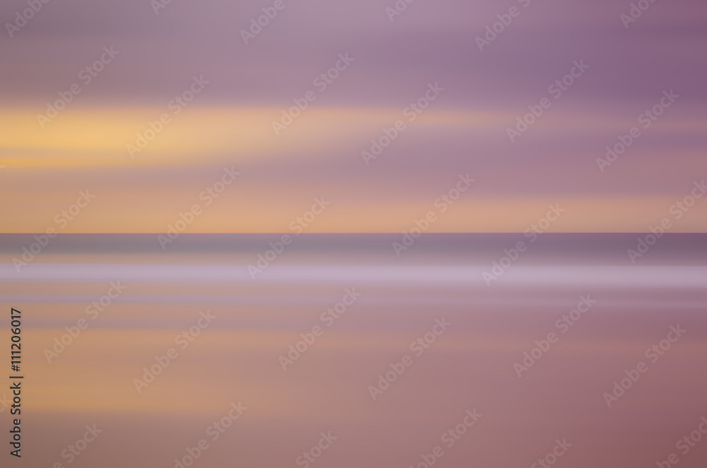 Motion blur tropical sunset beach and smooth wave. Travel concept.