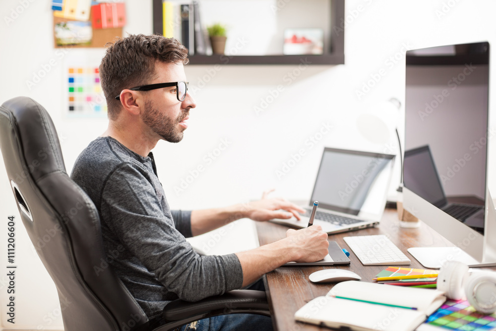 Handsome man multitasking at the office Handsome man multitasking at the office
