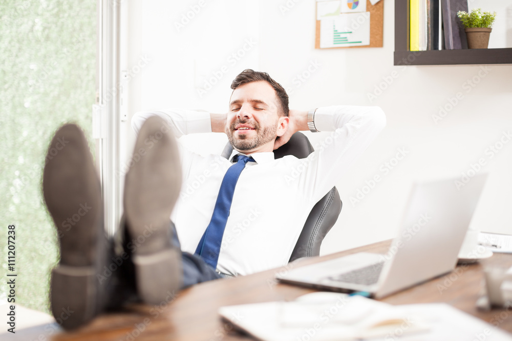 Businessman relaxing in his office Businessman relaxing in his office