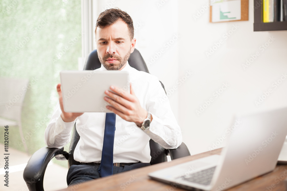 Businessman using a tablet in his office Businessman using a tablet in his office