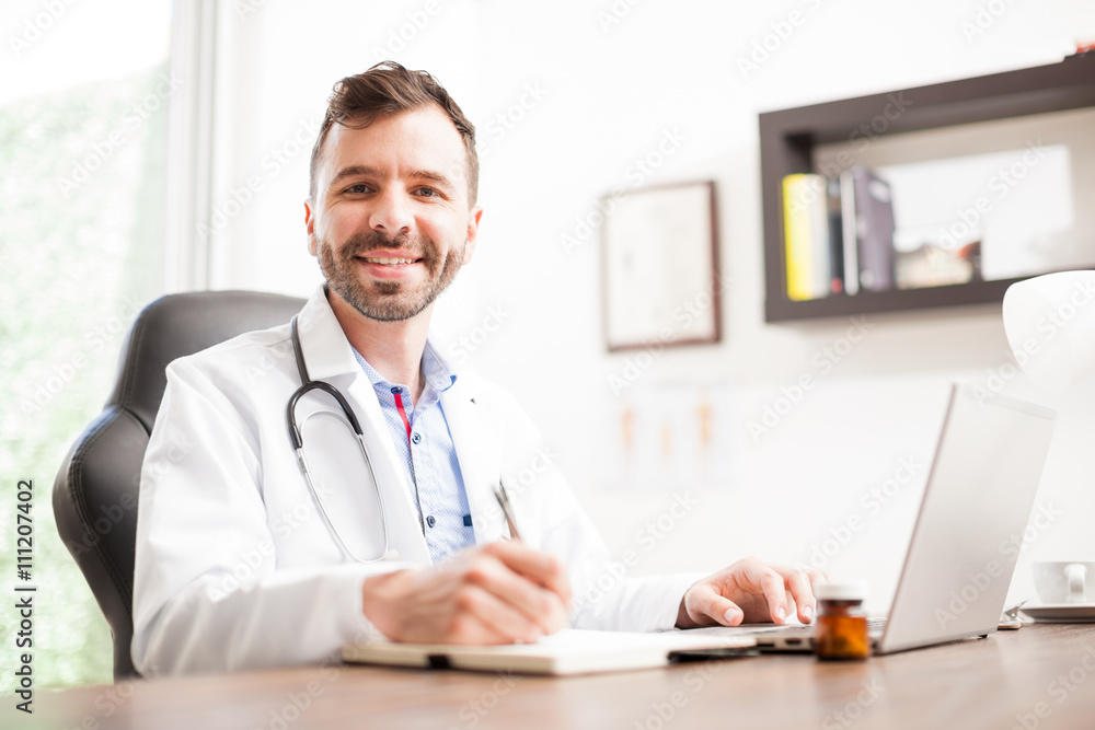Happy Hispanic doctor working in an office Happy Hispanic doctor working in an office