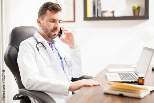 Pediatrician talking on the phone in an office