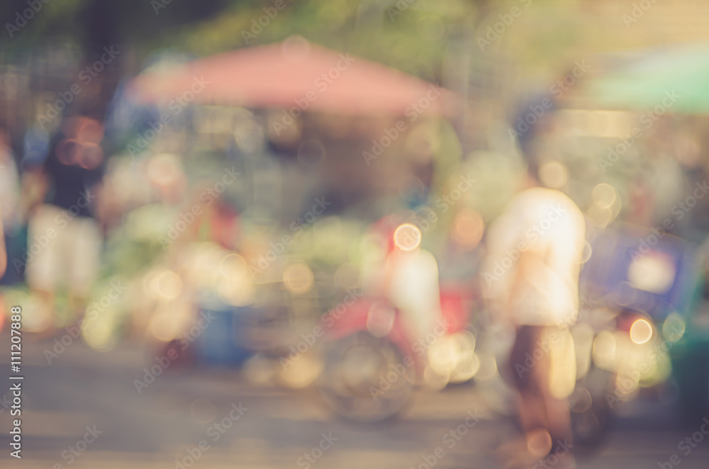 Blur people shopping in local street market with colorful bokeh and sun light abstract background.