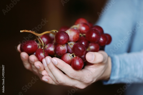 Man holding big bunch of grapes © Africa Studio