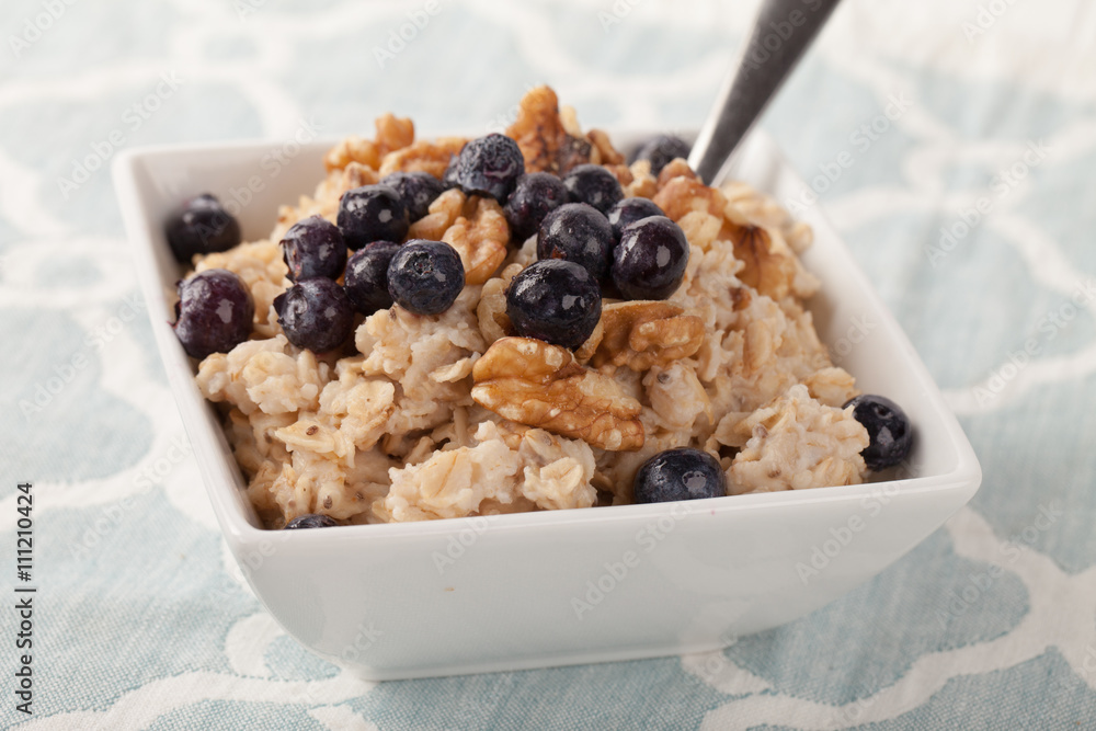 Oatmeal with chia seeds, brown sugar, blueberries, walnuts, and milk Oatmeal with chia seeds, brown sugar, blueberries, walnuts, and milk