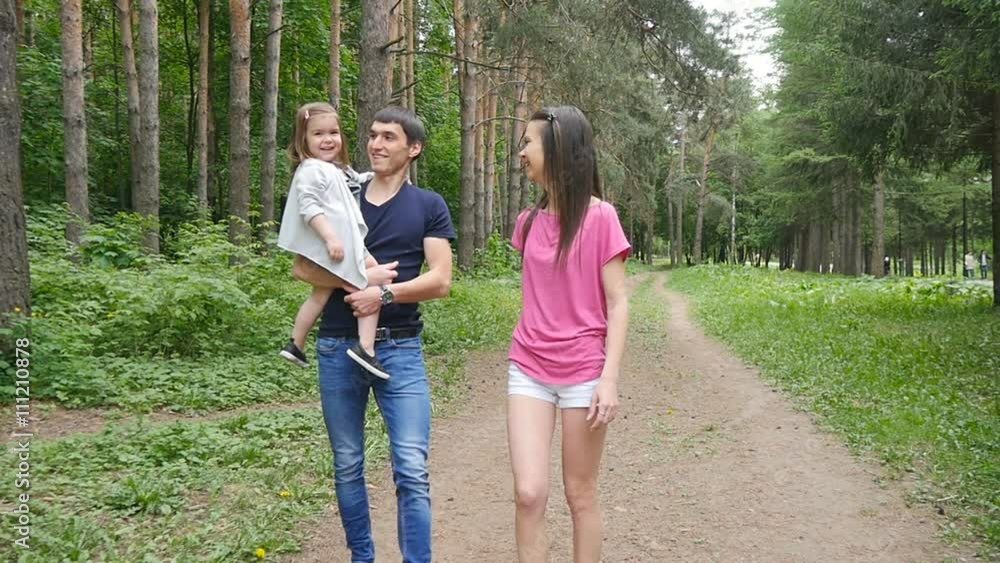 Happy Family on the Walk in Forest Happy Family on the Walk in Forest
