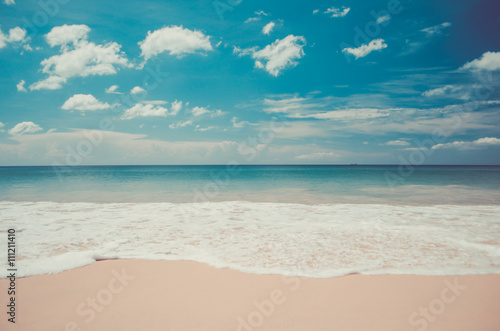 Blur tropical beach with bokeh sun light wave abstract background. Travel concept.