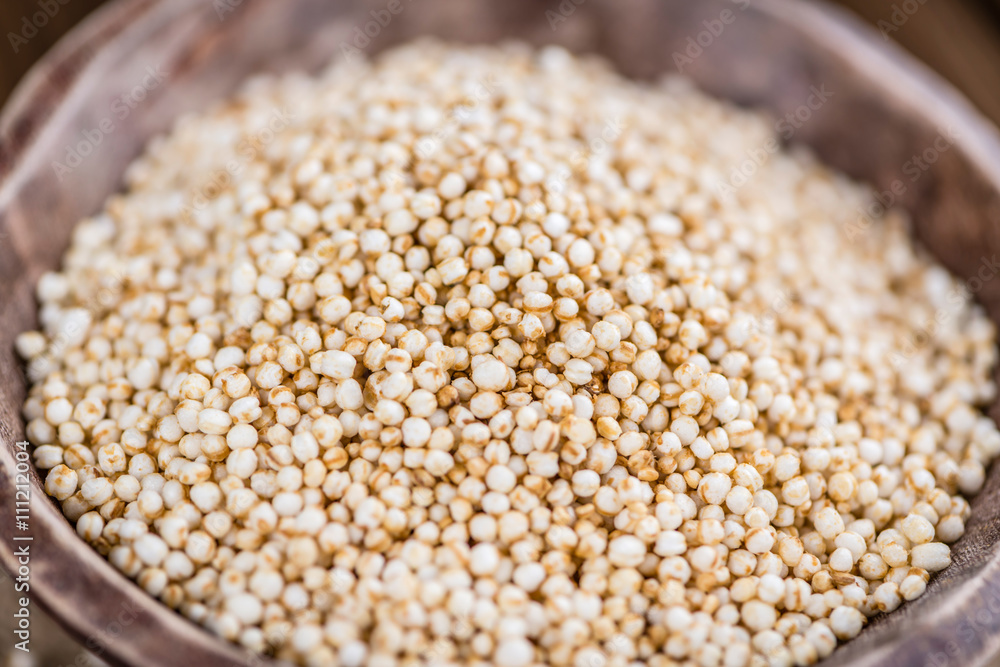 Puffed Quinoa (selective focus; close-up shot) on wooden backgro Puffed Quinoa (selective focus; close-up shot) on wooden backgro