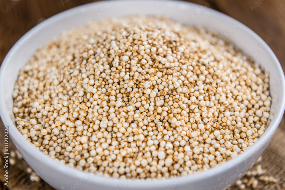 Puffed Quinoa (selective focus; close-up shot) on wooden backgro Puffed Quinoa (selective focus; close-up shot) on wooden backgro