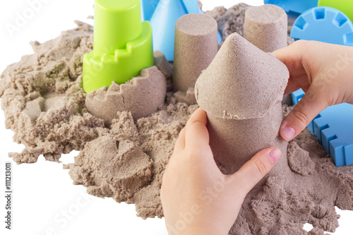 Fun kinetic sand.Child building sand castle