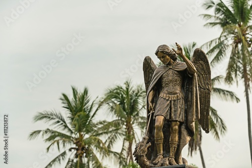 Murais de parede Archangel Michael Sculpture, The archangel isolated on isolated against a blue sky at sunlight