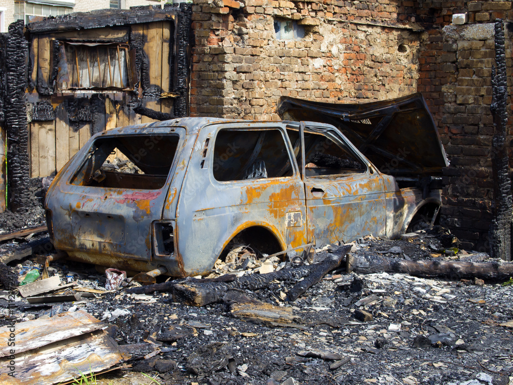 Fototapeta premium Burned garage and car