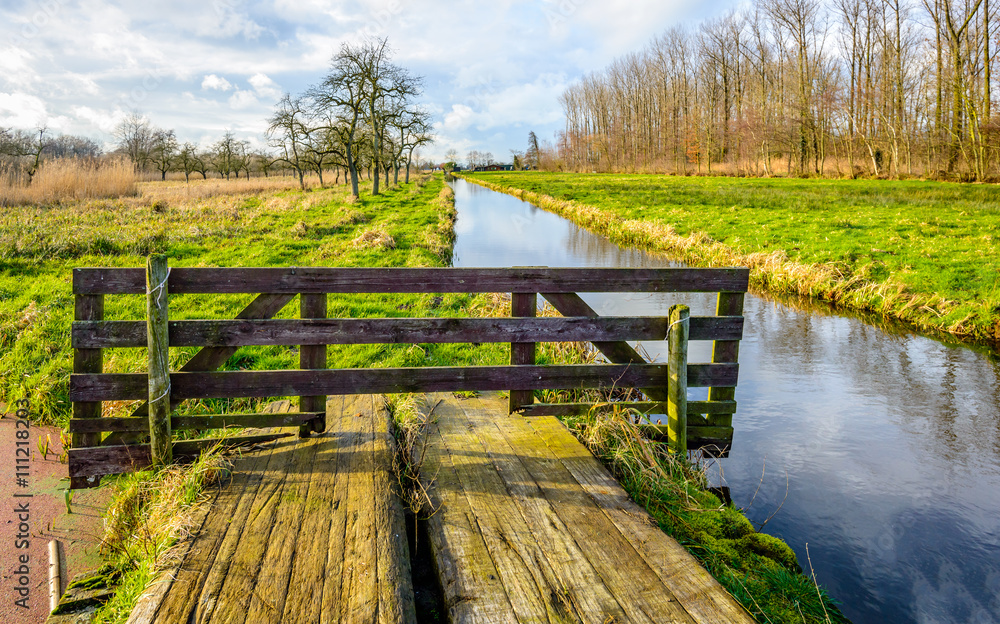 Colorful Dutch autumn landscape with a wooden gate Colorful Dutch autumn landscape with a wooden gate