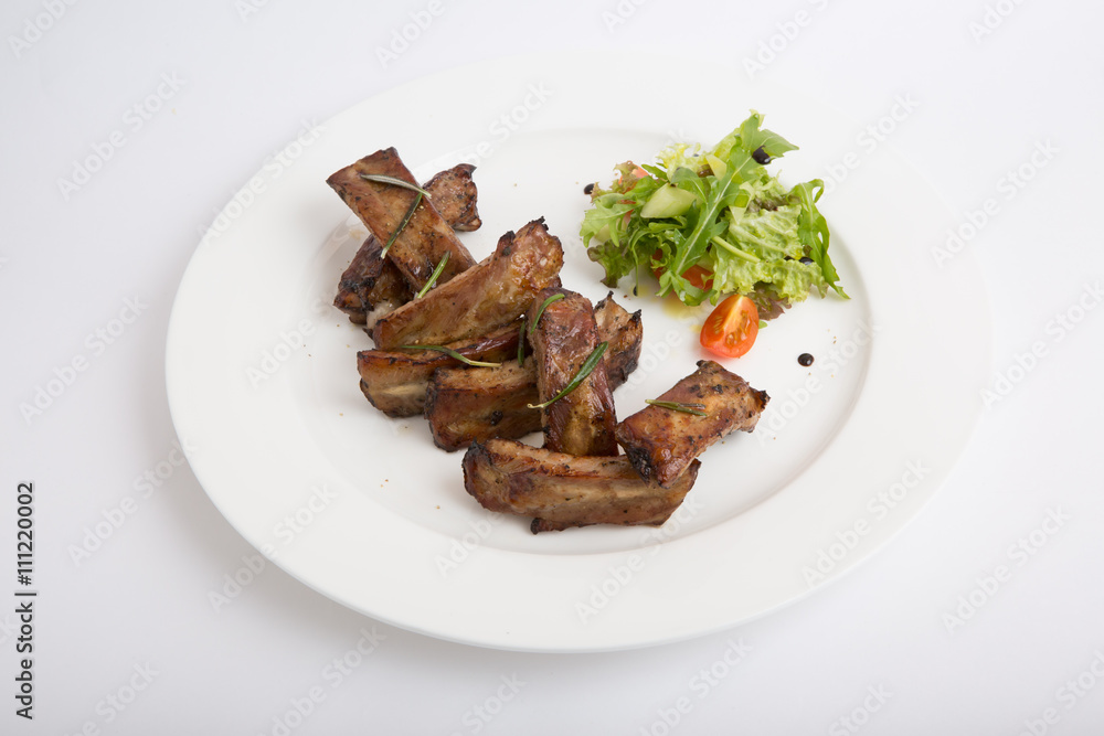 Fried ribs with salad