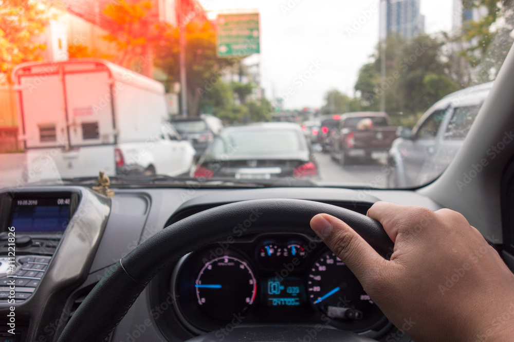 The Man hand driving car on the traffic jam , digital effect sunlight