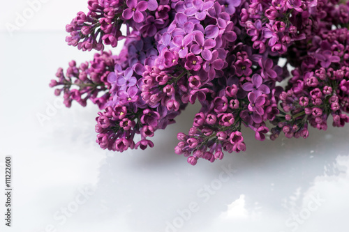 Bouquet of purple lilac on glass table