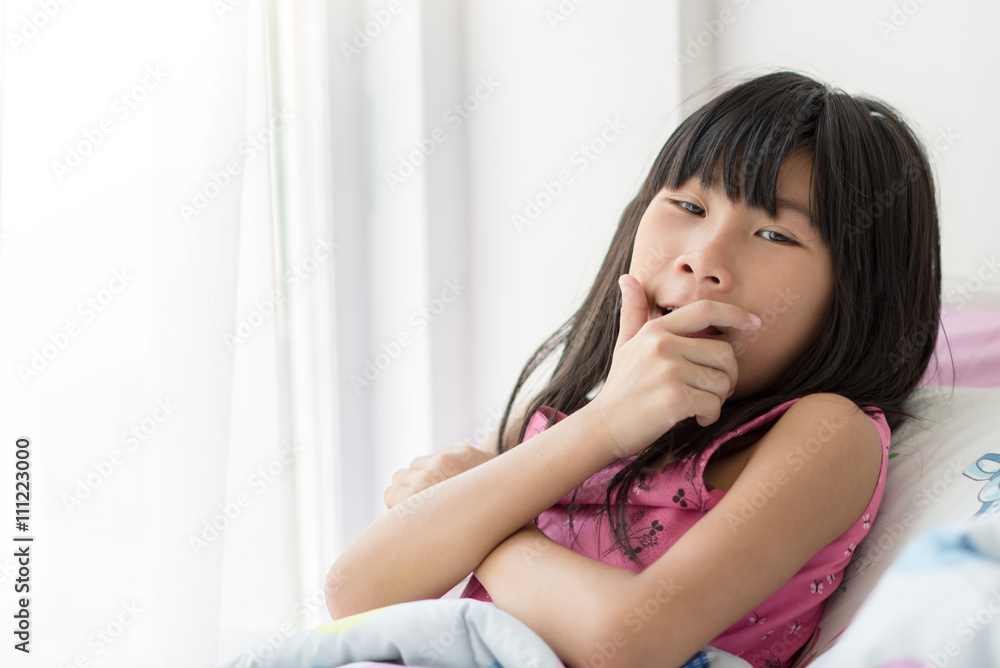 Cute Asian girl relaxing on bed at home with copyspace. Cute Asian girl relaxing on bed at home with copyspace.