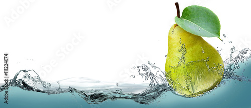 The fruit of a ripe pear on a background of splashing water. 