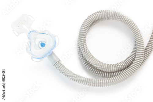 CPAP mask and hose on white background