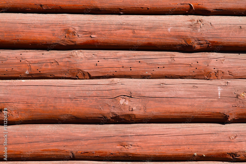 Brown wooden wall made of logs Brown wooden wall made of logs
