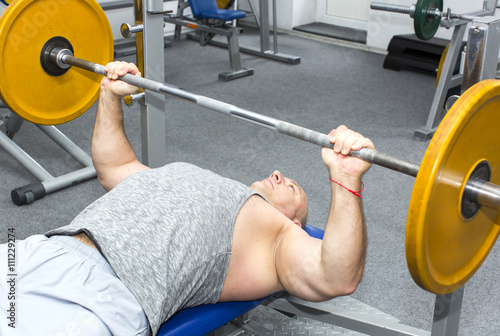 adult brutal man is engaged in sports bodybuilding