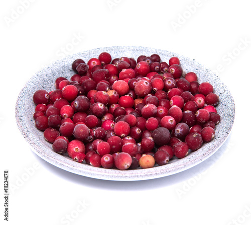 Cranberries in a wicker tray on awhite background